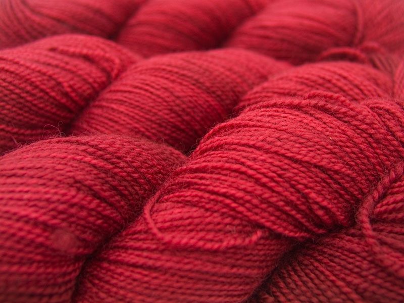 Semi-solid deep red superwash Bluefaced Leicester (BFL) 4-ply/fingering/sock yarn. Hand-dyed by Triskelion Yarn