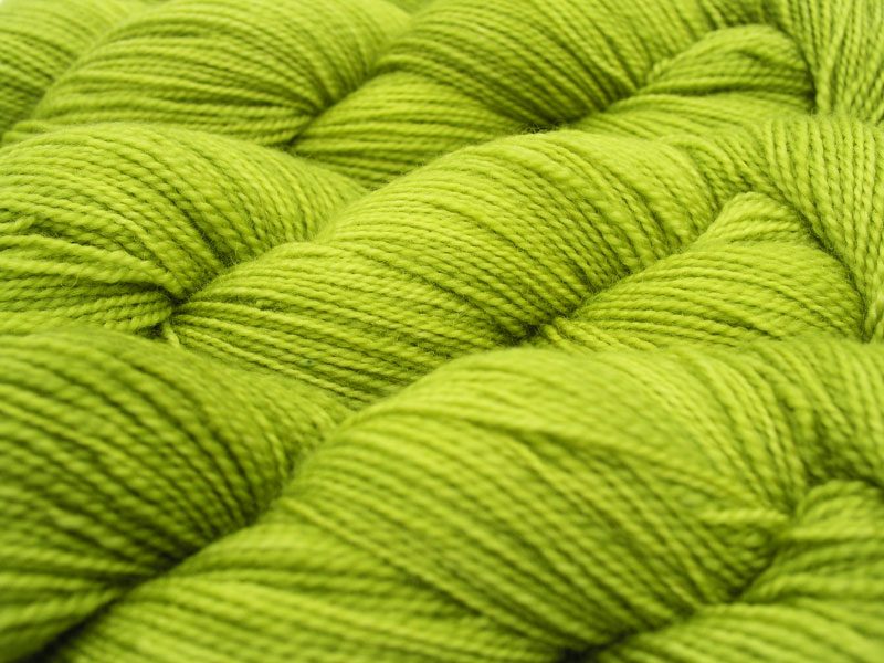 Semi-solid vibrant spring green superwash Bluefaced Leicester (BFL) 4-ply/fingering/sock yarn. Hand-dyed by Triskelion Yarn