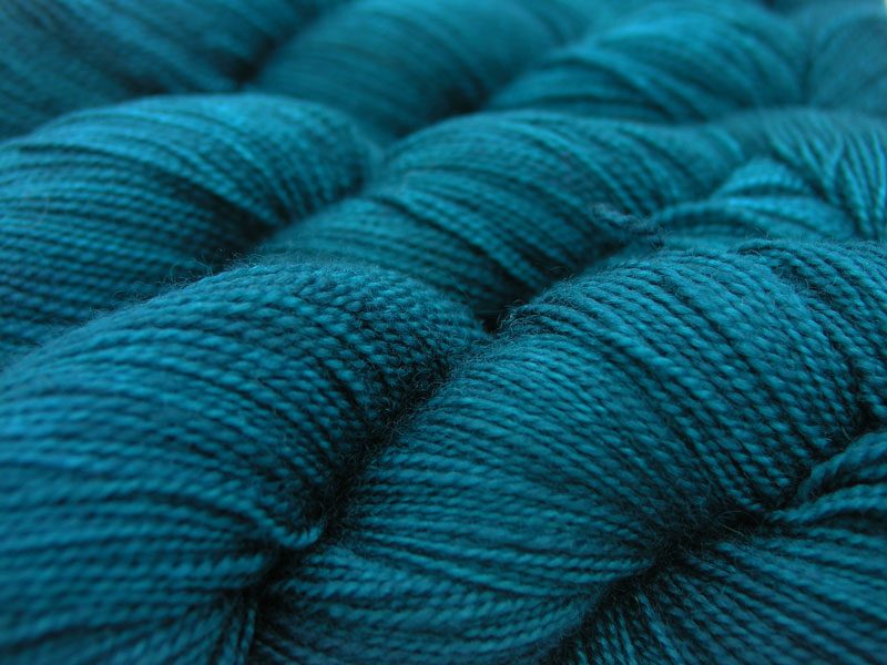 Semi-solid deep sea teal blue superwash Bluefaced Leicester (BFL) 4-ply/fingering/sock yarn. Hand-dyed by Triskelion Yarn