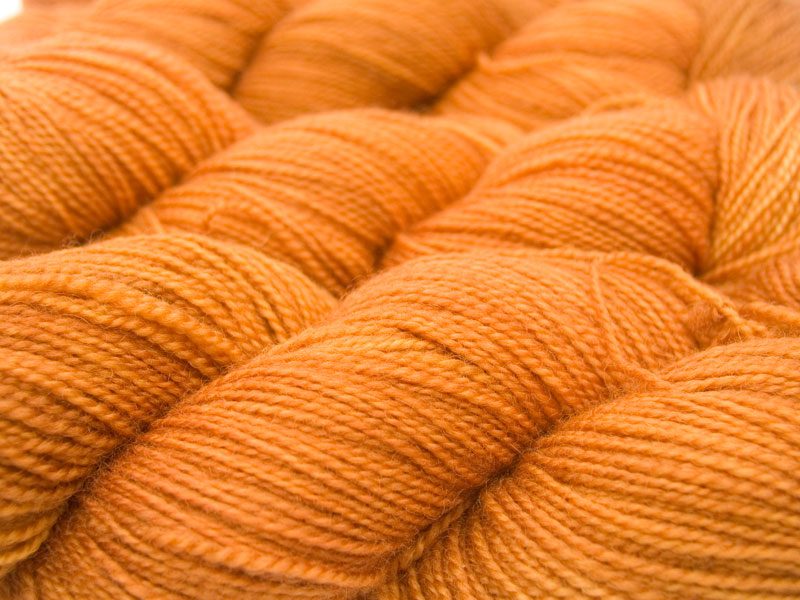 Semi-solid light fiery orange superwash Bluefaced Leicester (BFL) 4-ply/fingering/sock yarn. Hand-dyed by Triskelion Yarn
