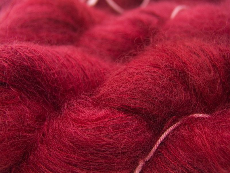 Deep ruby red kidsilk laceweight yarn. Hand-dyed by Triskelion Yarn