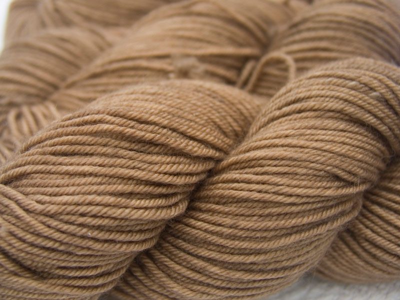 Light to mid-tone golden brown Bluefaced Leicester, silk & cashmere double knit yarn. Hand-dyed by Triskelion Yarn.