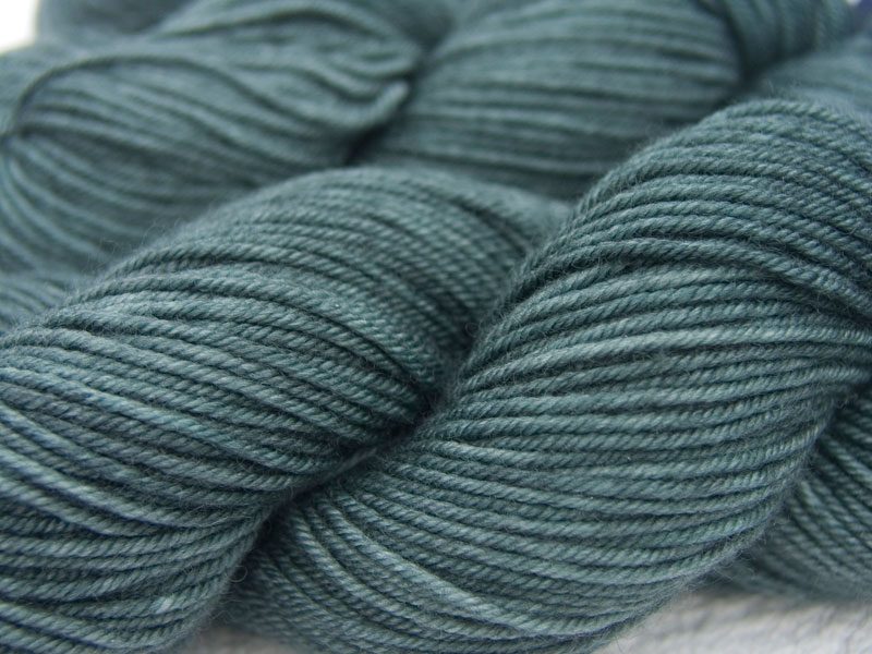 Mid-tone greenish sea grey Bluefaced Leicester, silk & cashmere double knit yarn. Hand-dyed by Triskelion Yarn.