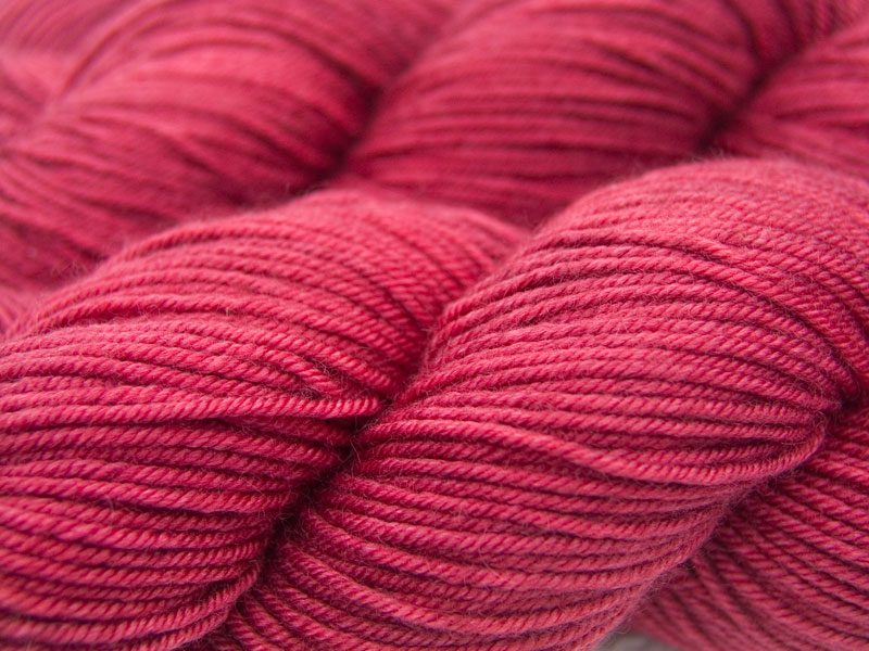 Deep,vibrant rose Bluefaced Leicester, silk & cashmere double knit yarn. Hand-dyed by Triskelion Yarn.