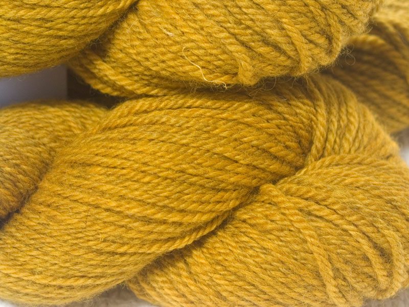 Semi-solid golden yellow Bluefaced Leicester (BFL) / Masham aran yarn. Hand-dyed by Triskelion Yarn