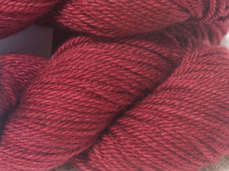 Semi-solid deep rose Bluefaced Leicester (BFL) / Masham aran yarn. Hand-dyed by Triskelion Yarn