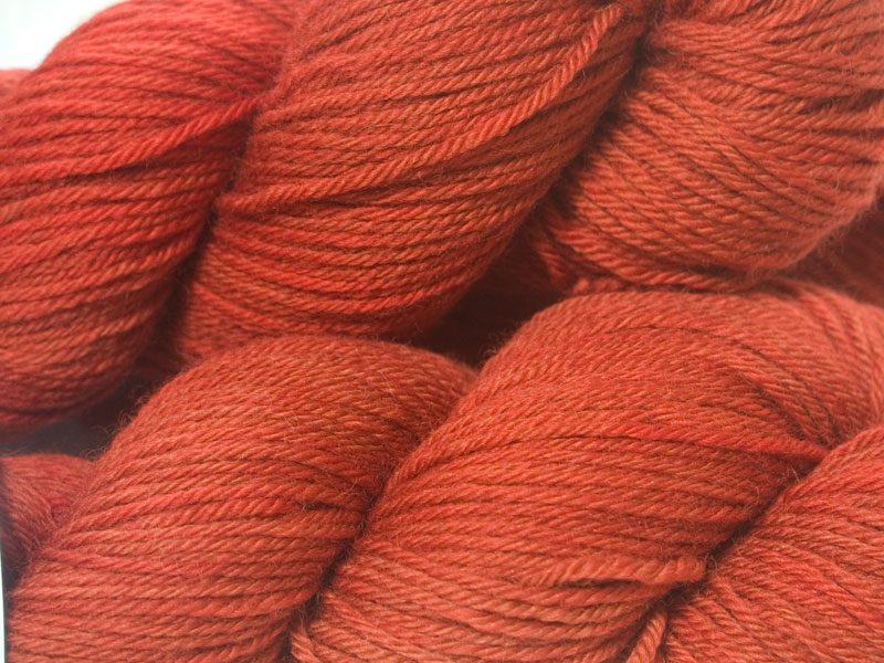 Orange red superwash British Bluefaced Leicester sportweight yarn. hand-dyed by Triskelion Yarn
