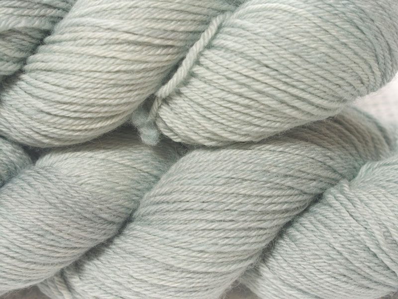 Light grey superwash British Bluefaced Leicester sportweight yarn. hand-dyed by Triskelion Yarn