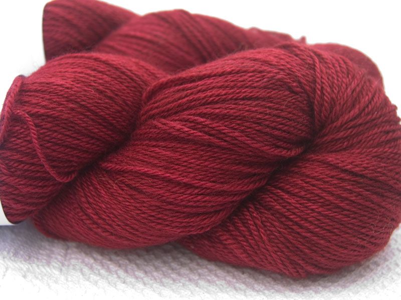 Deep red Bluefaced Leicester, silk & cashmere 4-ply yarn. Hand-dyed by Triskelion Yarn.