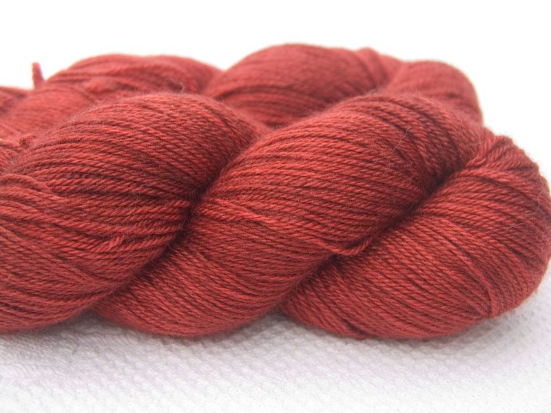 Orange red Bluefaced Leicester, silk & cashmere 4-ply yarn. Hand-dyed by Triskelion Yarn.
