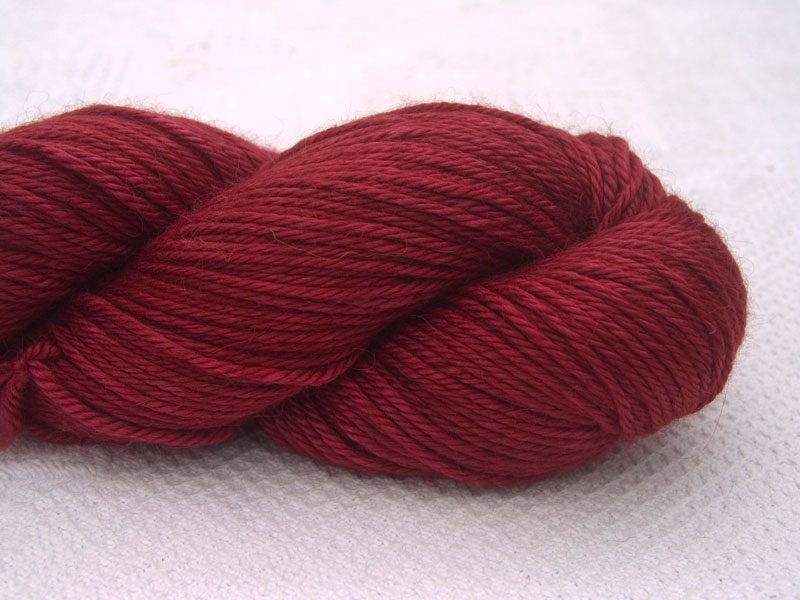 Deep red Baby Alpaca Silk & Cashmere double-knit yarn. Hand-dyed by Triskelion Yarn.