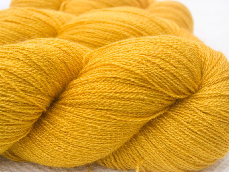 Yellow Bluefaced Leicester laceweight yarn. Hand-dyed by Triskelion Yarn.