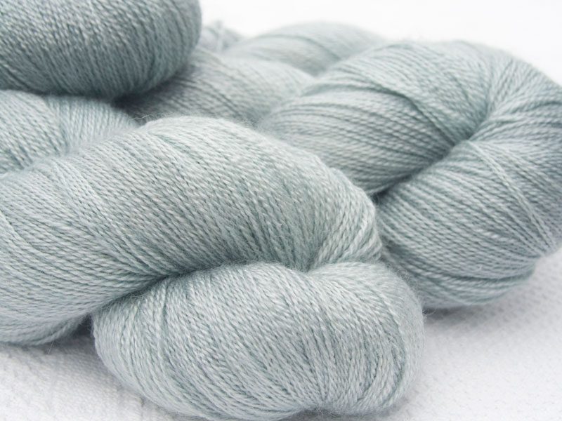 Light grey Bluefaced Leicester laceweight yarn. Hand-dyed by Triskelion Yarn.