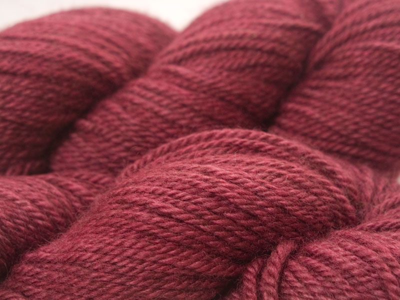 Rich mid-tone rose Bluefaced Leicester (BFL) / Masham aran yarn. Hand-dyed by Triskelion Yarn