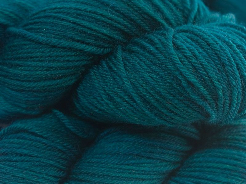 Deep teal with hints of sea green superwash British Bluefaced Leicester sportweight yarn. hand-dyed by Triskelion Yarn