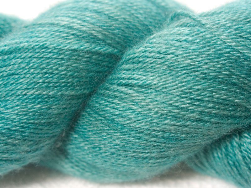 Turquoise green Bluefaced Leicester, silk & cashmere 4-ply yarn. Hand-dyed by Triskelion Yarn.