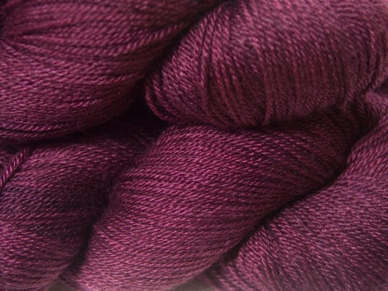 Mid-tone violet red Bluefaced Leicester, silk & cashmere 4-ply yarn. Hand-dyed by Triskelion Yarn.