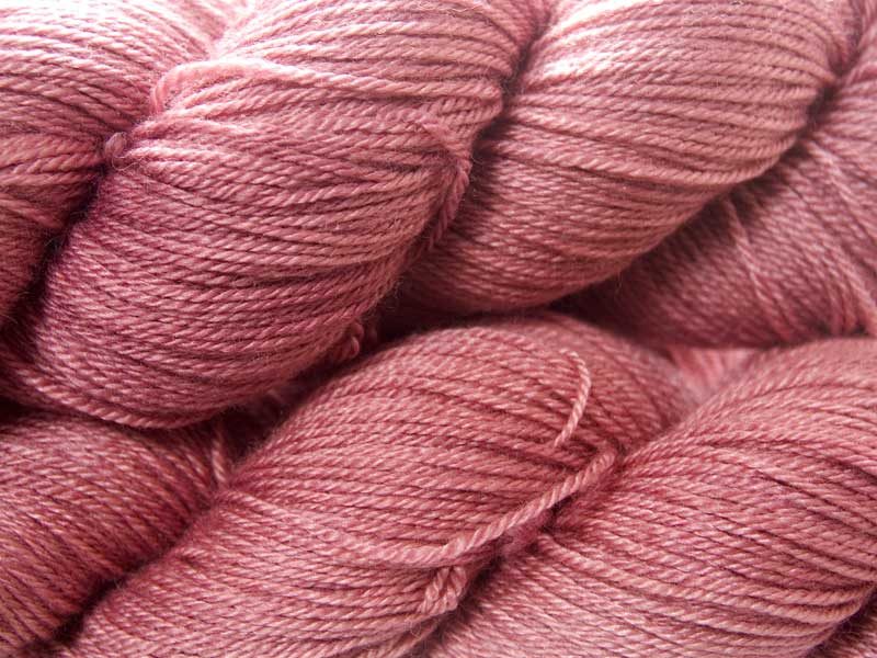 Semi-solid vibrant rose pink Bluefaced Leicester, silk & cashmere 4-ply yarn. Hand-dyed by Triskelion Yarn.
