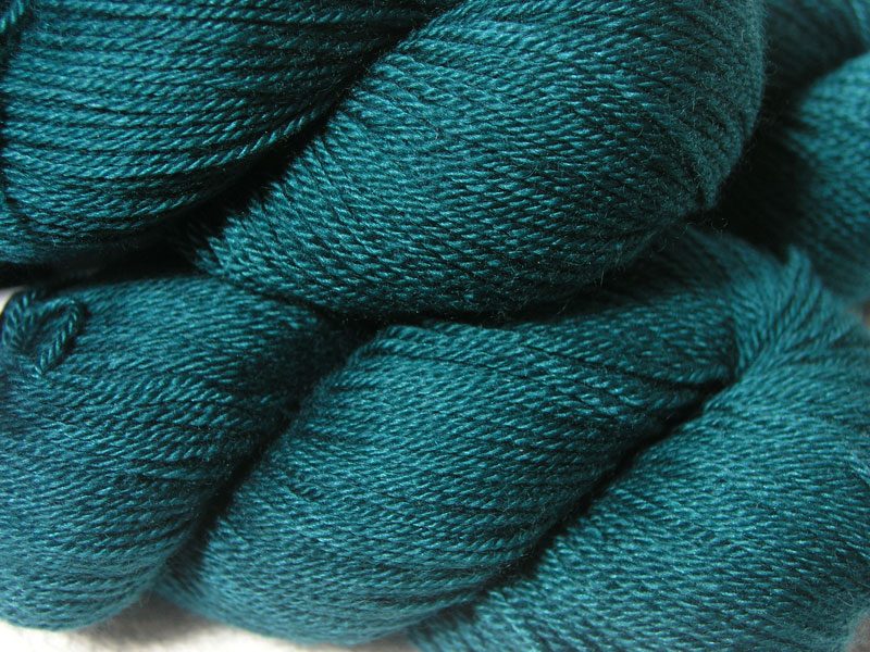Mid to dark teal green Bluefaced Leicester, silk & cashmere 4-ply yarn. Hand-dyed by Triskelion Yarn.