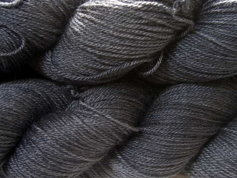 Dark slate grey Bluefaced Leicester, silk & cashmere 4-ply yarn. Hand-dyed by Triskelion Yarn.