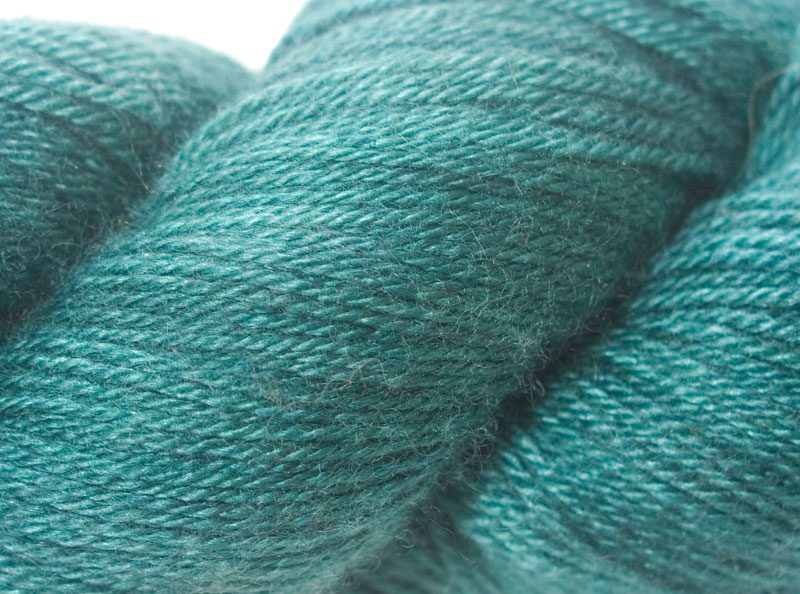 Semi-solid mid-tone blue-green Bluefaced Leicester, silk & cashmere 4-ply yarn. Hand-dyed by Triskelion Yarn.