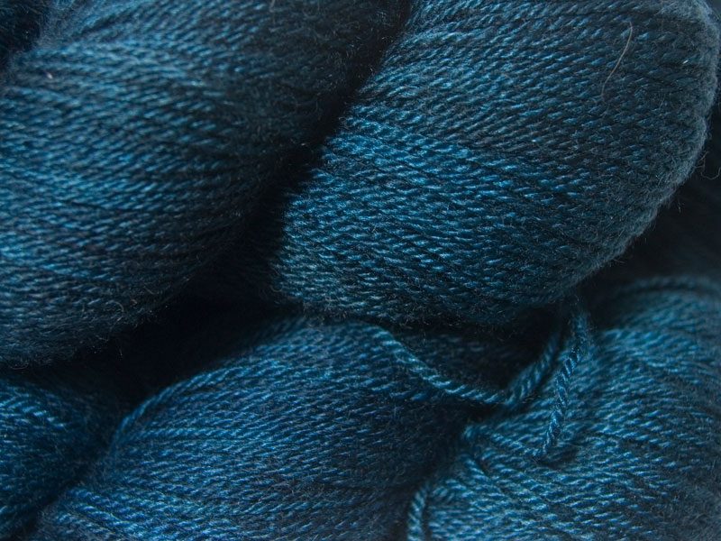 Dark neutral blue Bluefaced Leicester, silk & cashmere 4-ply yarn. Hand-dyed by Triskelion Yarn.