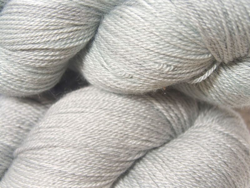 Semi-solid to solid bright bluish grey Bluefaced Leicester, silk & cashmere 4-ply yarn. Hand-dyed by Triskelion Yarn.
