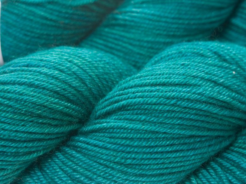 Mid-tone blue-green Bluefaced Leicester, silk & cashmere double knit yarn. Hand-dyed by Triskelion Yarn.