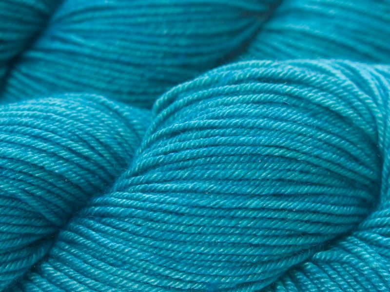 Mid-tone turquoise green Bluefaced Leicester, silk & cashmere double knit yarn. Hand-dyed by Triskelion Yarn.