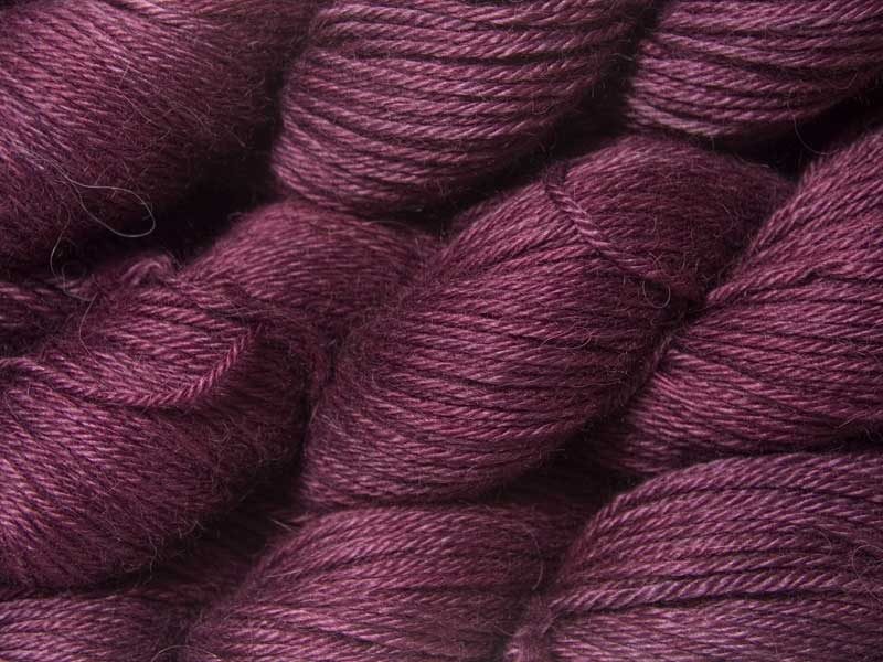 Mid-tone violet red Baby Alpaca Silk & Cashmere double-knit yarn. Hand-dyed by Triskelion Yarn.