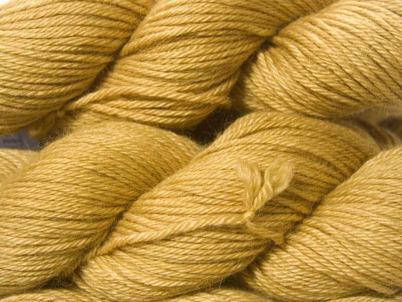 Sandy golden yellow Baby Alpaca Silk & Cashmere double-knit yarn. Hand-dyed by Triskelion Yarn.