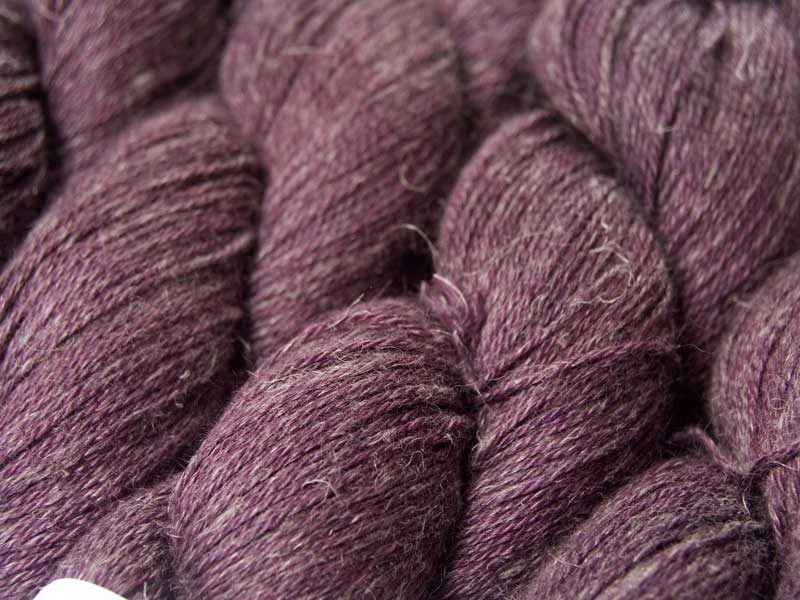 Mid-tone violet red Baby Alpaca, silk and linen 4-ply yarn. Hand-dyed by Triskelion Yarn.