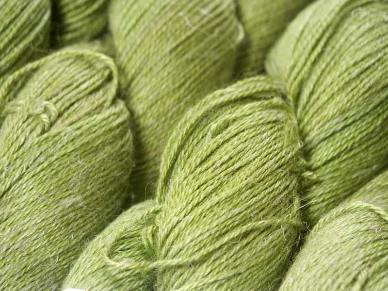Mid-tone grassy green Baby Alpaca, silk and linen 4-ply yarn. Hand-dyed by Triskelion Yarn.