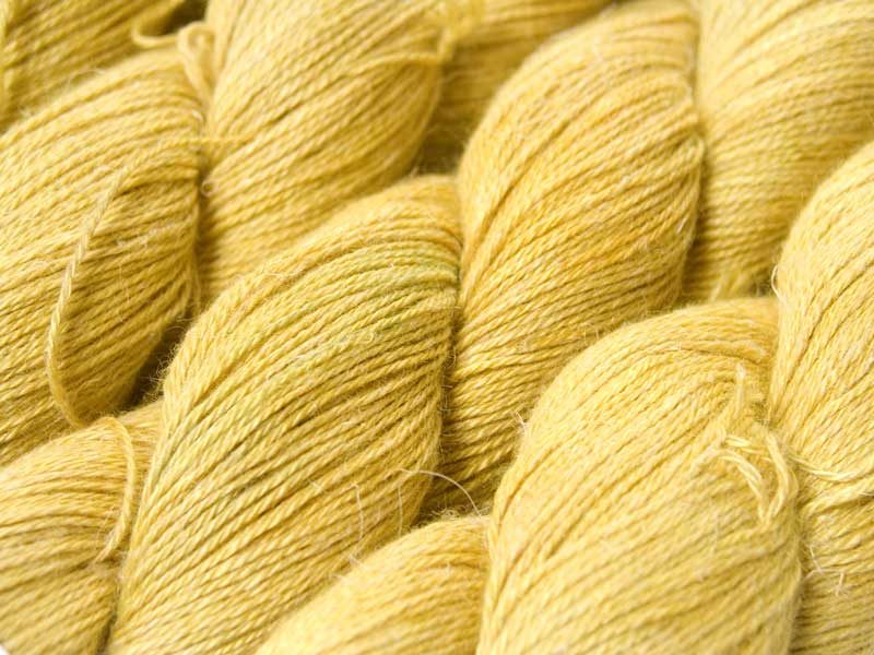 Pale, fresh yellow Baby Alpaca, silk and linen 4-ply yarn. Hand-dyed by Triskelion Yarn.