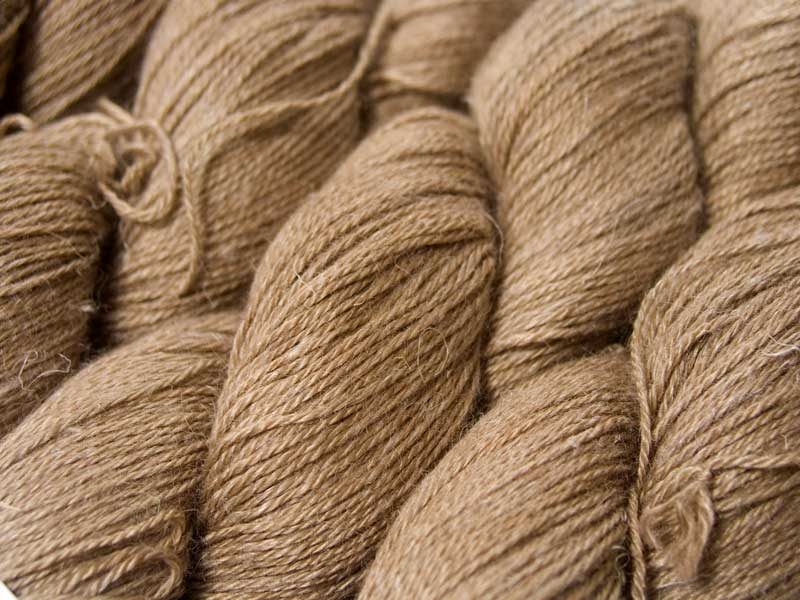 Light to mid brown Baby Alpaca, silk and linen 4-ply yarn. Hand-dyed by Triskelion Yarn.