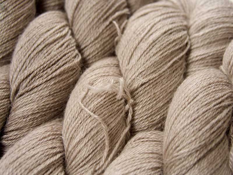 Light pebble grey Baby Alpaca, silk and linen 4-ply yarn. Hand-dyed by Triskelion Yarn.
