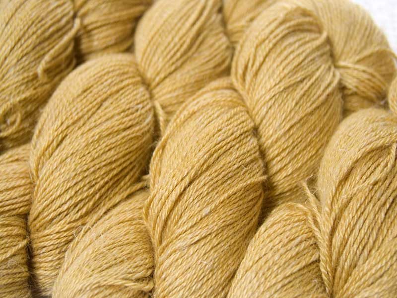 Sandy golden yellow Baby Alpaca, silk and linen 4-ply yarn. Hand-dyed by Triskelion Yarn.