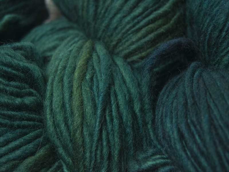 Mid to dark teal green Corriedale thick and thin slub yarn. Hand-dyed by Triskelion Yarn.