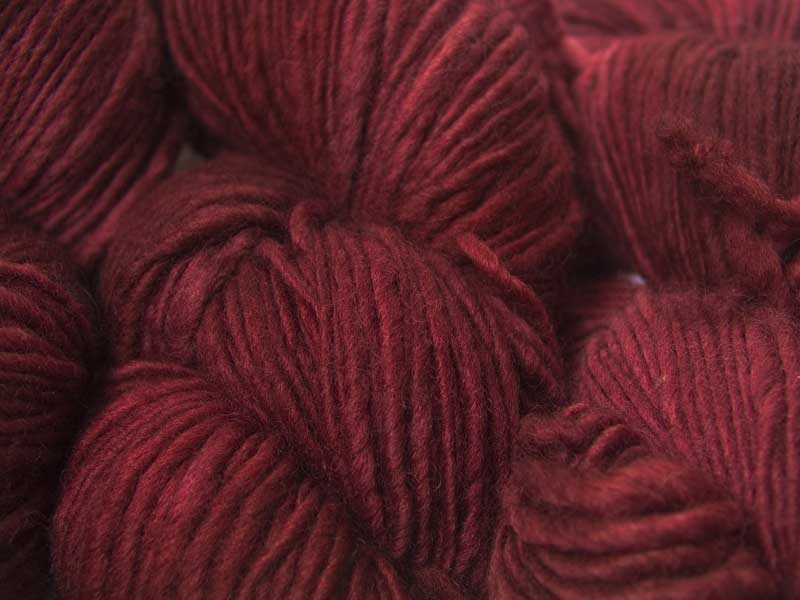 Deep, rich red Corriedale thick and thin slub yarn. Hand-dyed by Triskelion Yarn.