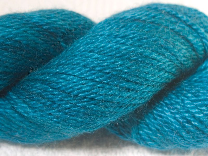 Mid-tone turquoise baby alpaca / silk aran yarn. Hand-dyed by Triskelion Yarn.