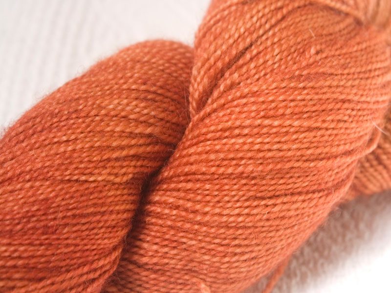 Terracotta orange superwash Bluefaced Leicester (BFL) 4-ply/fingering/sock yarn. Hand-dyed by Triskelion Yarn