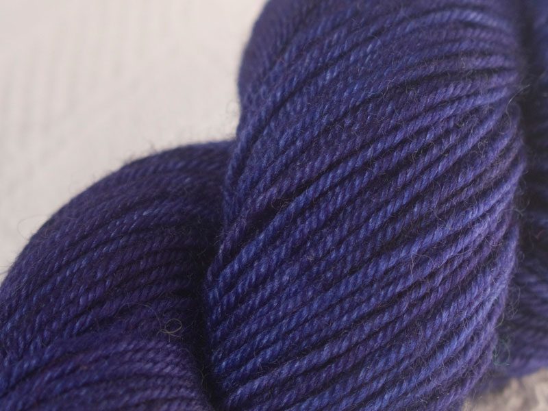 Deep violet purple superwash Bluefaced Leicester (BFL) double knit yarn. Hand-dyed by Triskelion Yarn