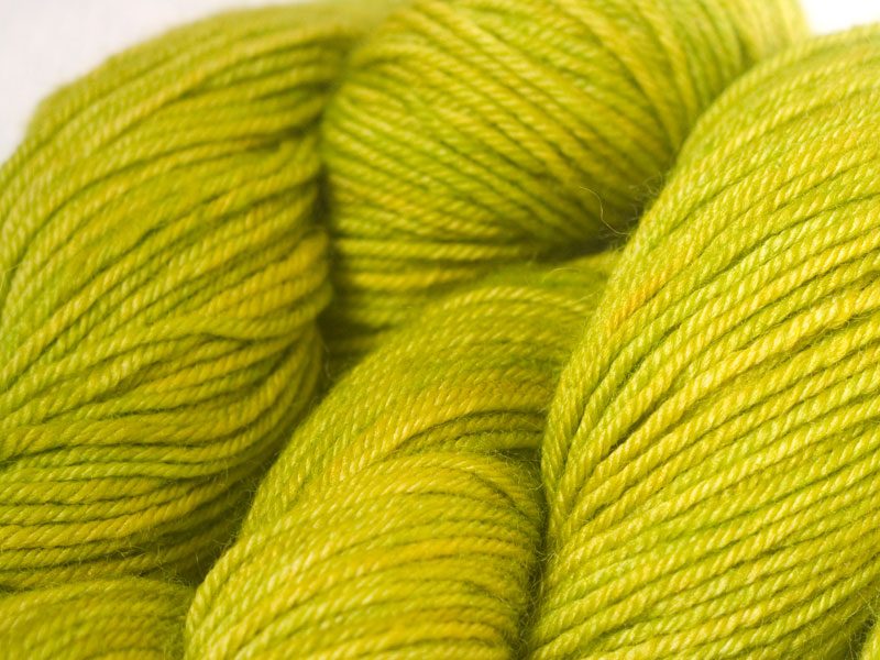 Semi-solid vibrant spring green superwash Bluefaced Leicester (BFL) double knit yarn. Hand-dyed by Triskelion Yarn