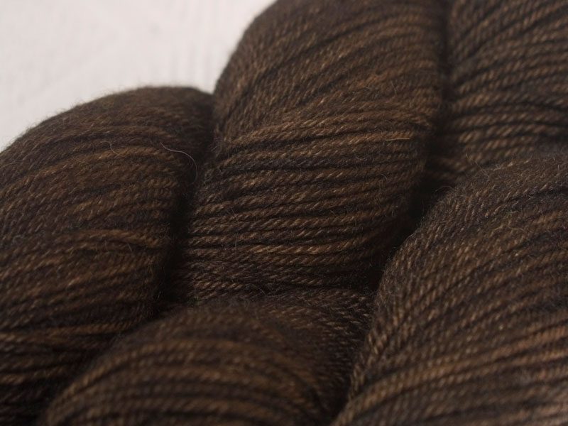 Semi-solid to solid rich dark brown superwash Bluefaced Leicester (BFL) double knit yarn. Hand-dyed by Triskelion Yarn