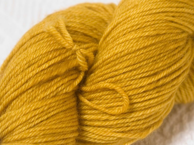 Ochre superwash Bluefaced Leicester (BFL) double knit yarn. Hand-dyed by Triskelion Yarn