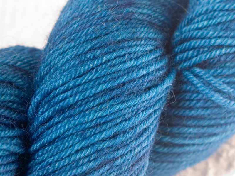 Semi-solid cerulean blue superwash Bluefaced Leicester (BFL) double knit yarn. Hand-dyed by Triskelion Yarn