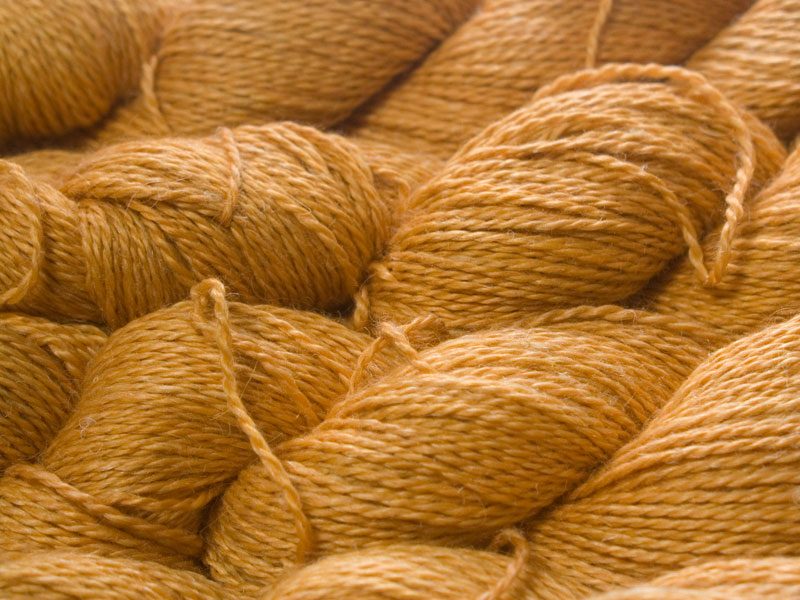 Fresh light to mid orange Baby Alpaca, silk and linen sport weight yarn. Hand-dyed by Triskelion Yarn.