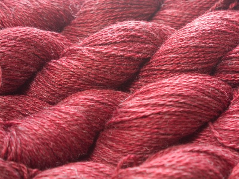 Semi-solid deep red Baby Alpaca, silk and linen sport weight yarn. Hand-dyed by Triskelion Yarn.