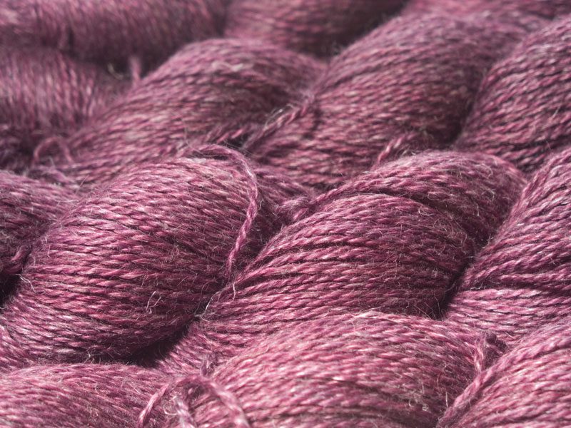 Mid-tone violet red Baby Alpaca, silk and linen sport weight yarn. Hand-dyed by Triskelion Yarn.