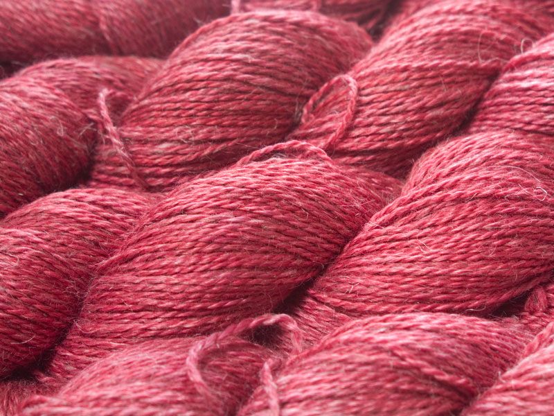 Semi-solid deep rose Baby Alpaca, silk and linen sport weight yarn. Hand-dyed by Triskelion Yarn.
